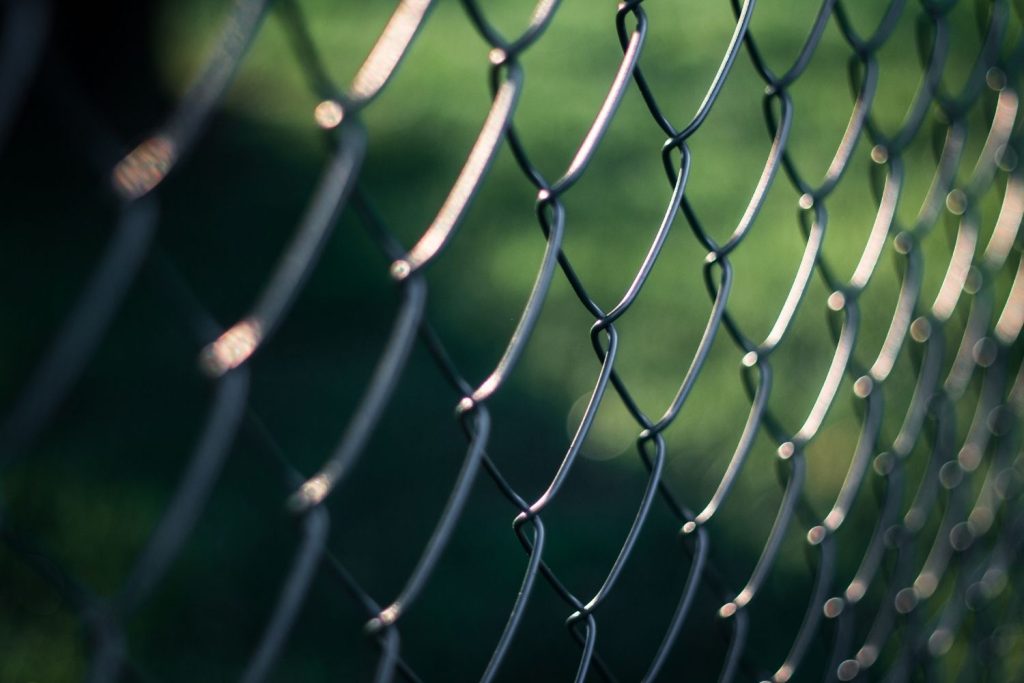angled view of a galvanized chain-link fence