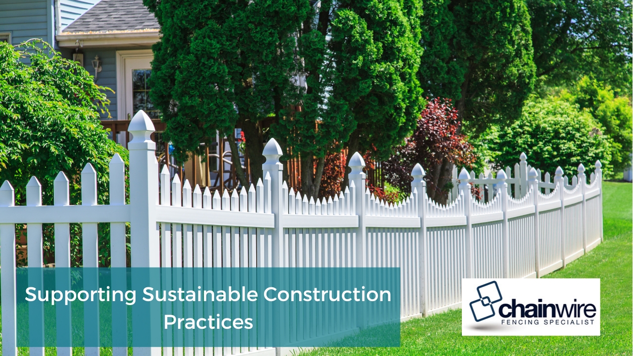 Beautiful residential property with a white picket fence, surrounded by lush greenery and trees.