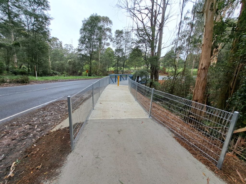 a newly constructed concrete boardwalk and pedestrian path